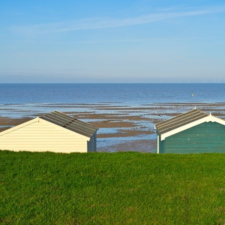 Amble past beach huts and along sandy shores on our Kent walking holiday