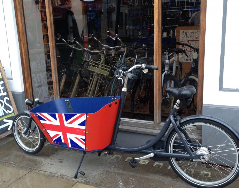 A cargo bicycle painted with the British flag outside a shop in London