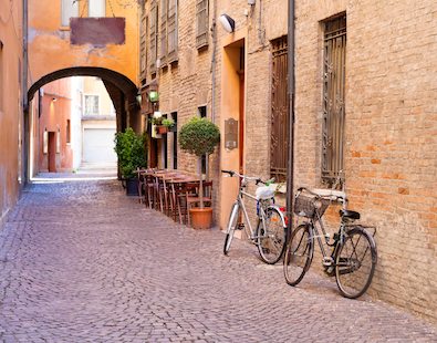 Two bikes resting against the wall on an old French street on our Provence cycling holiday