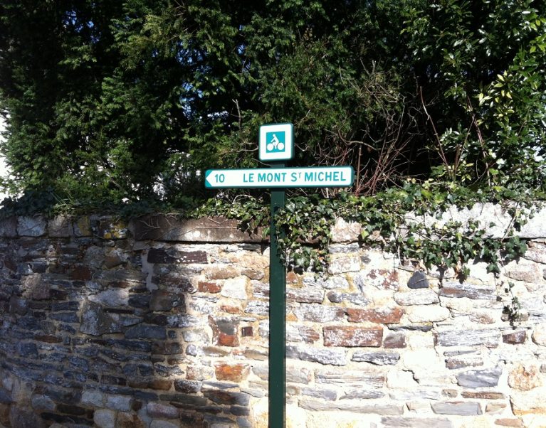 Signpost showing the cycle route to Mont St Michel in Brittany, France - photographed on a Carter Company cycling tour