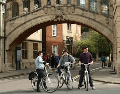 Three cyclists on a bike holiday in Oxford, pausing under the Bridge of Sighs